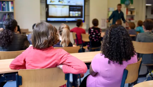 Modern smart classroom setup with interactive display and conferencing system for digital learning.